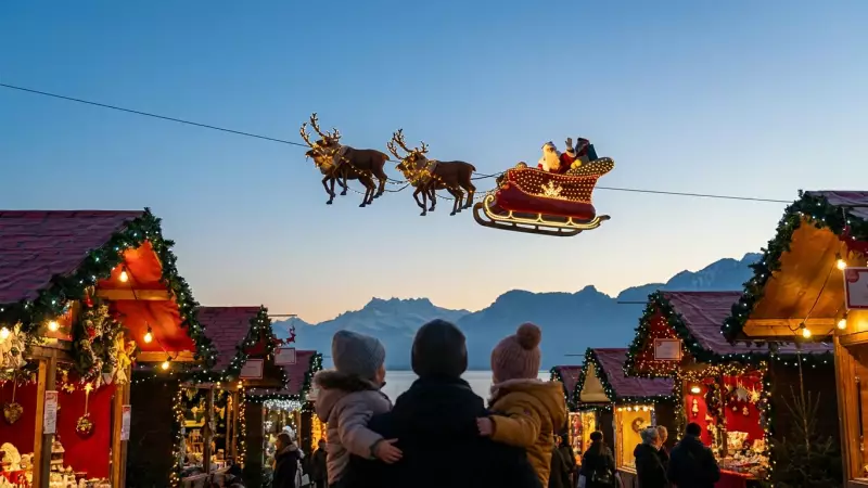 Le Père Noël et son traîneau survolent les chalets du marché de Noël de Montreux au crépuscule, sous le regard d'une famille